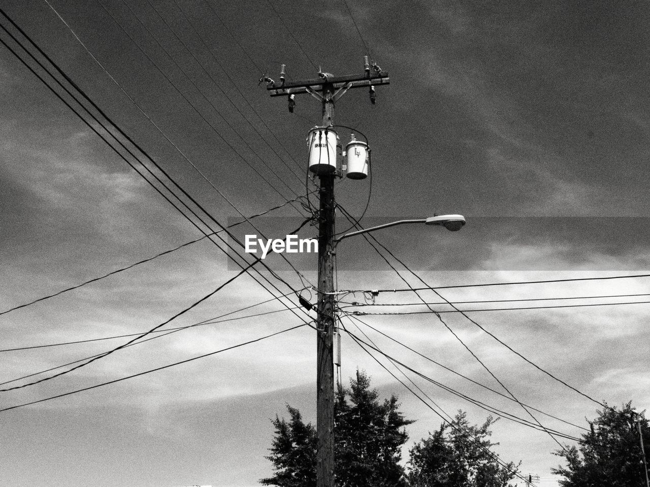 Low angle view of electricity pylon against sky