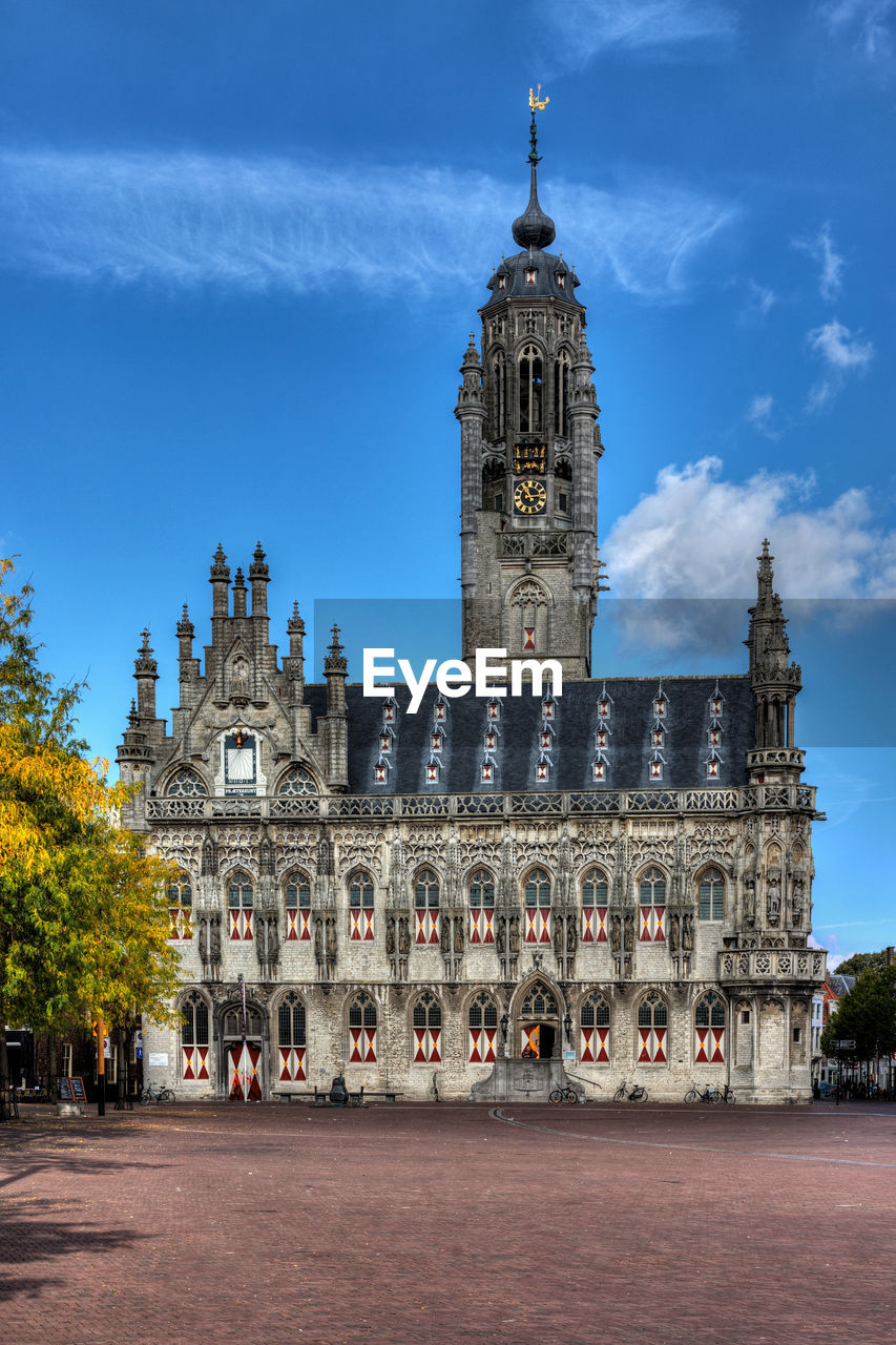 Clock tower in city against sky