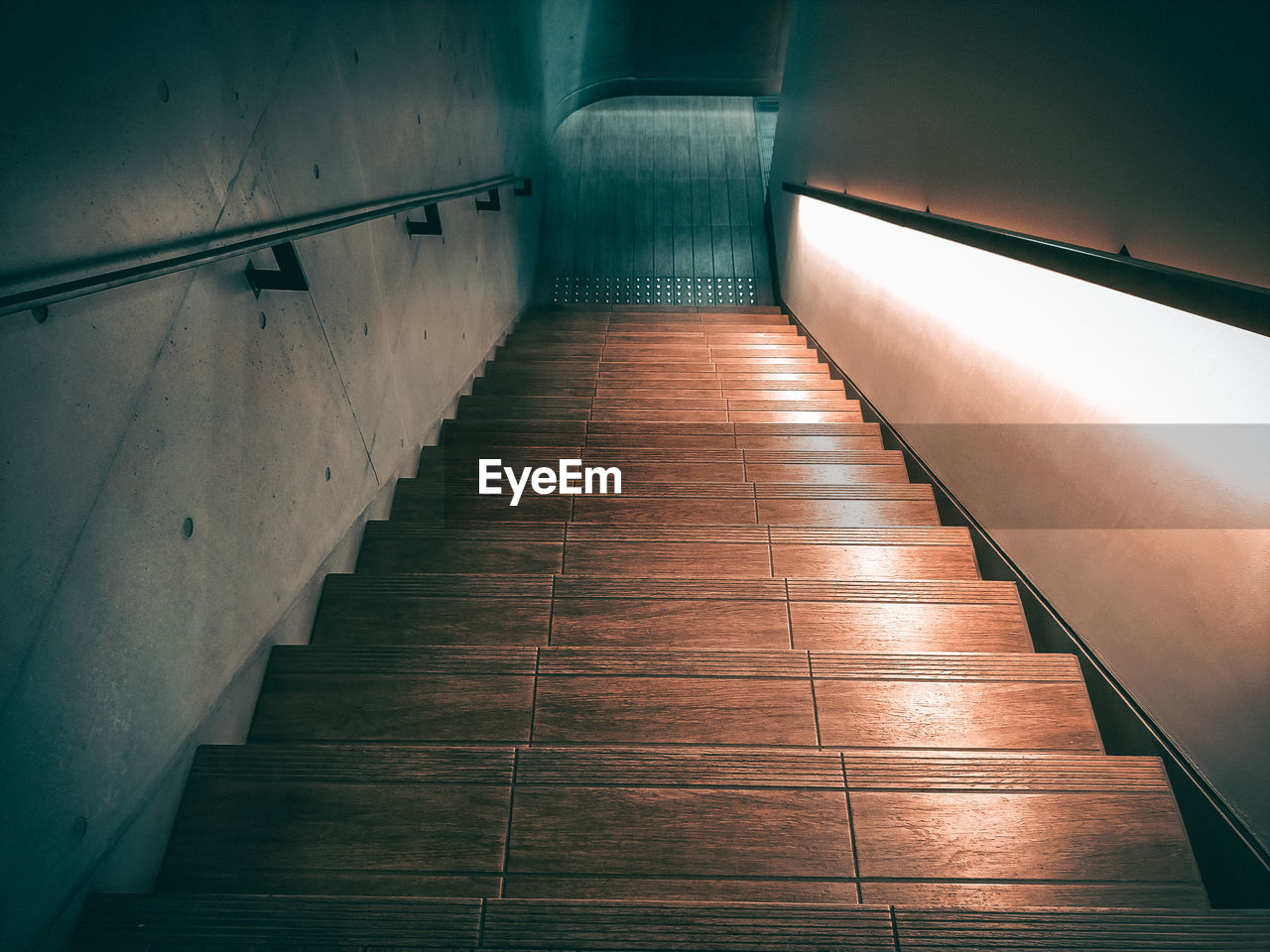 light, darkness, architecture, reflection, no people, indoors, line, blue, built structure, staircase, night, flooring, the way forward, wall - building feature, absence, wood, empty, lighting, illuminated, railing
