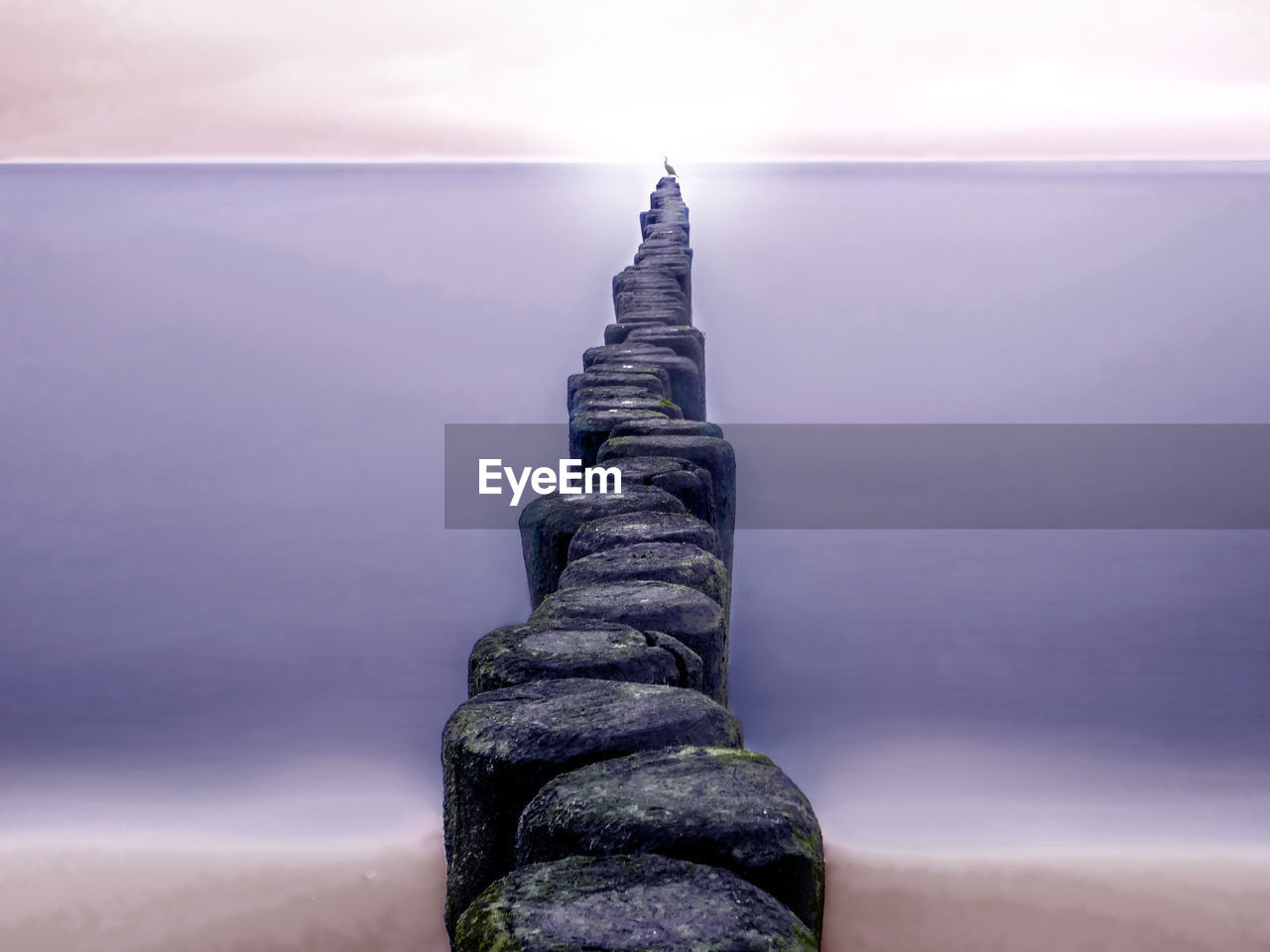 View of rock in sea against sky