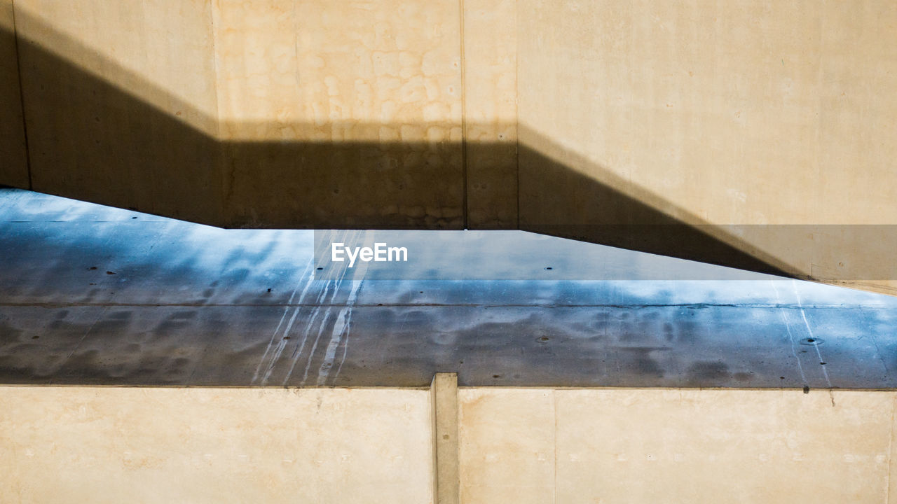 CLOSE-UP OF SWIMMING POOL WITH SHADOW