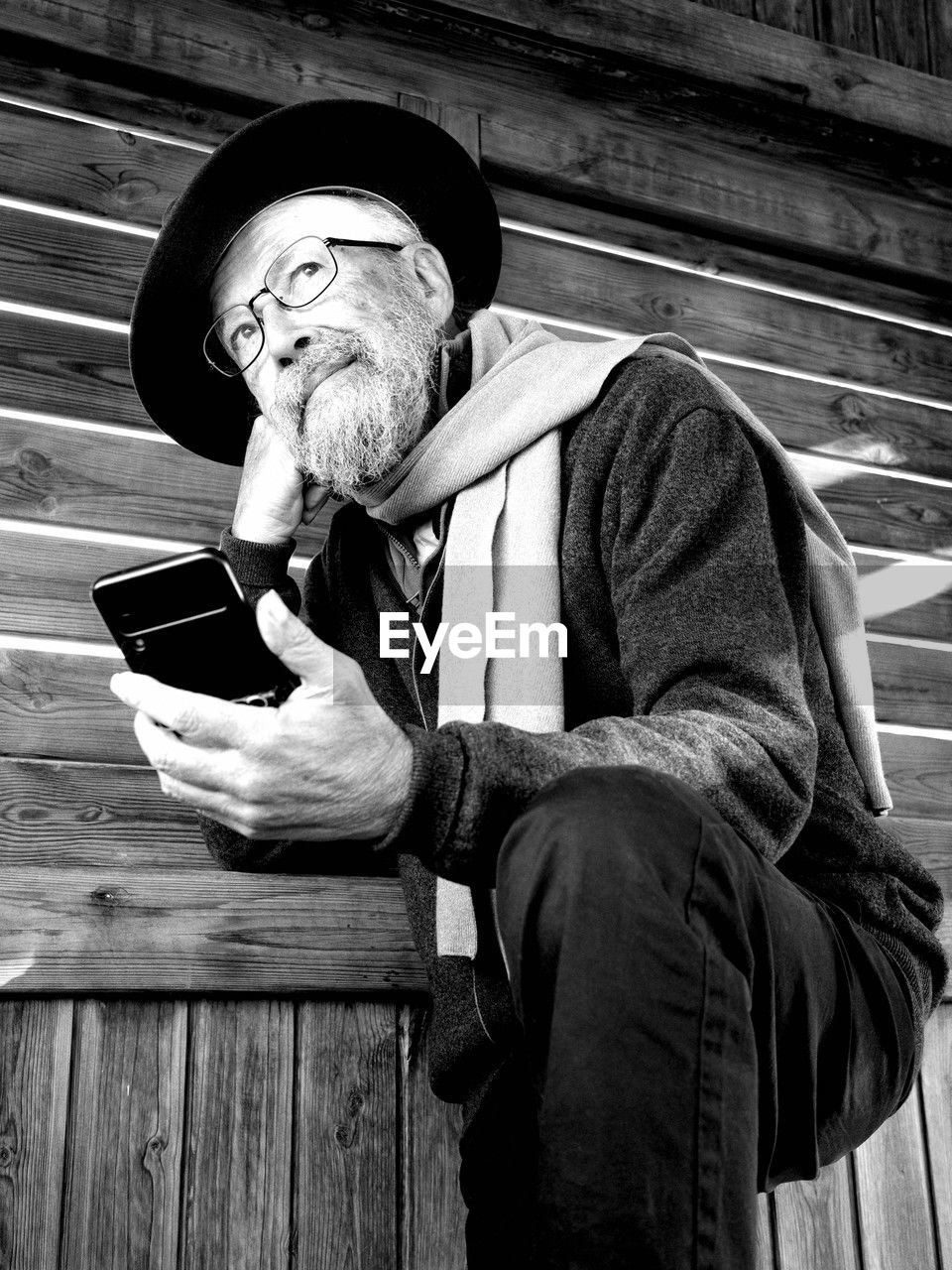 black, adult, men, one person, black and white, senior adult, person, monochrome, hat, clothing, white, sitting, monochrome photography, wood, facial hair, lifestyles, mature adult, beard, portrait, communication, relaxation, emotion, waist up, activity, poverty, holding, architecture, seniors, bench, human face, leisure activity