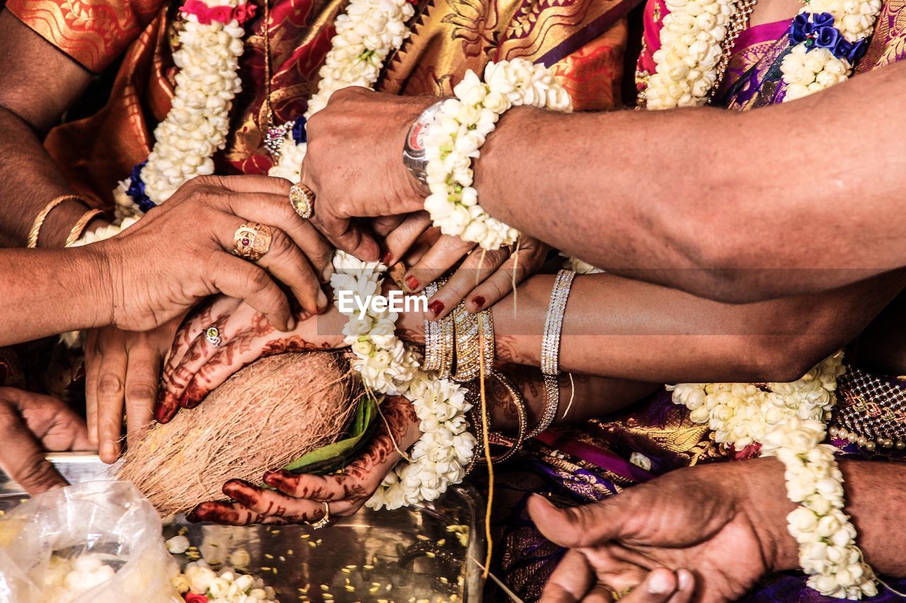 Close-up midsection of people during wedding ceremony