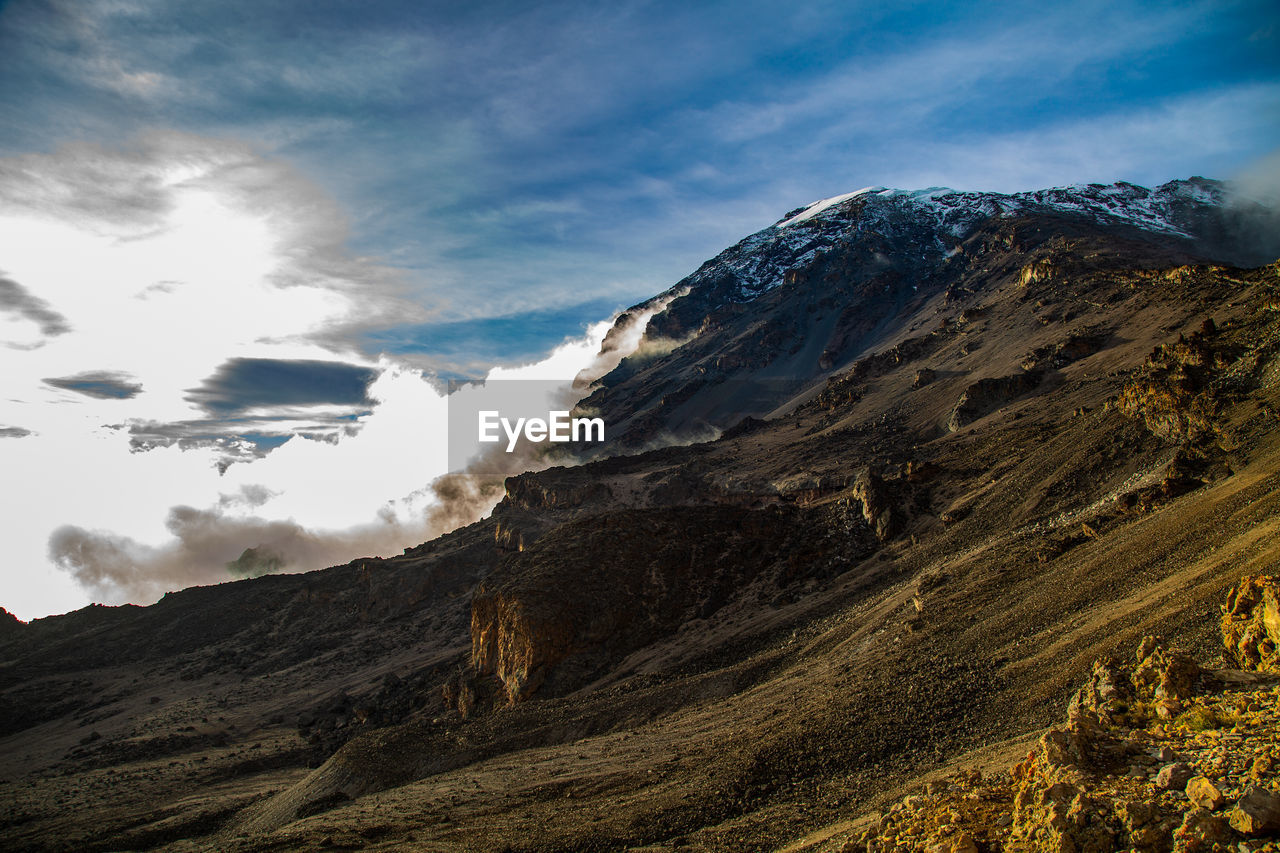 Clouds rolling over the peak of mt. kilimanjaro