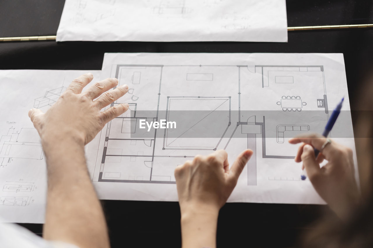 Colleagues reviewing business plan on table at office