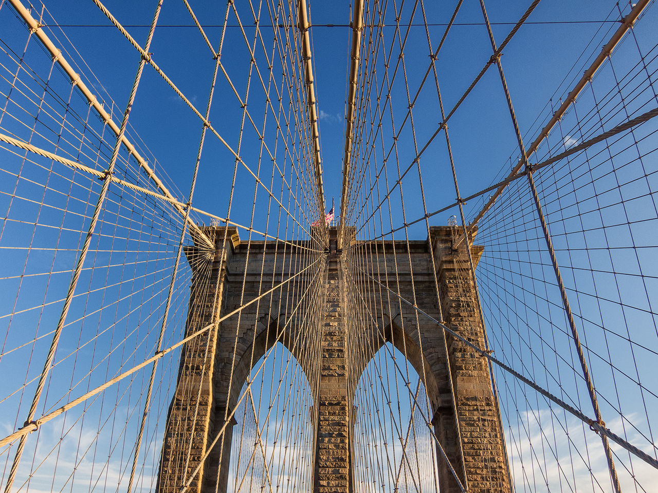 Low angle view of suspension bridge against sky