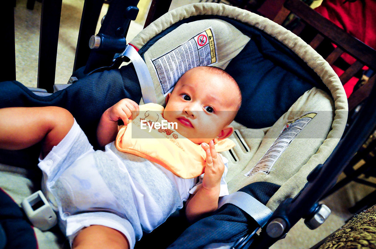 Portrait of cute boy relaxing in stroller