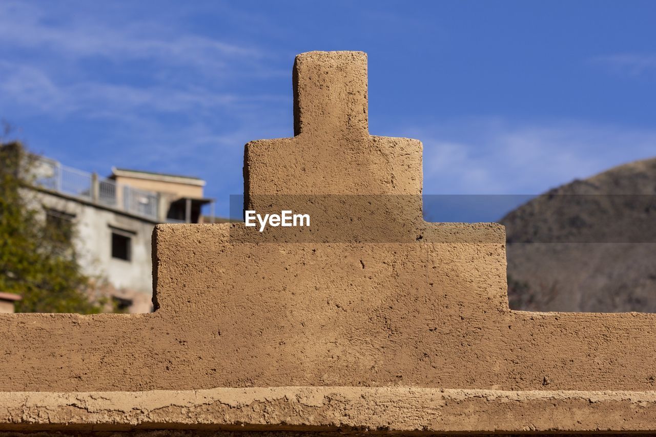 architecture, monument, built structure, sand, sky, ancient history, building exterior, history, the past, rock, nature, ruins, no people, wall, building, cloud, blue, land, outdoors, temple, travel destinations, stone material, day, ancient, fort, travel, fortification