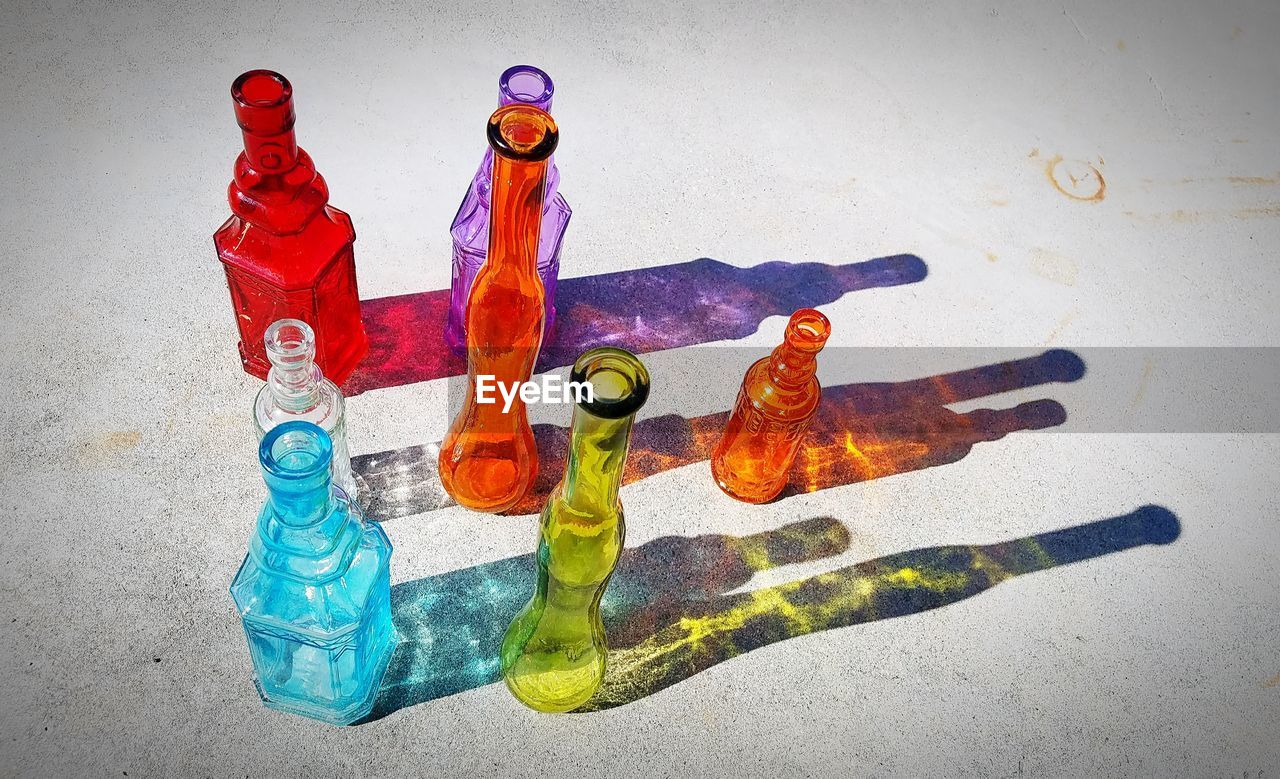 High angle view of colorful bottles on footpath