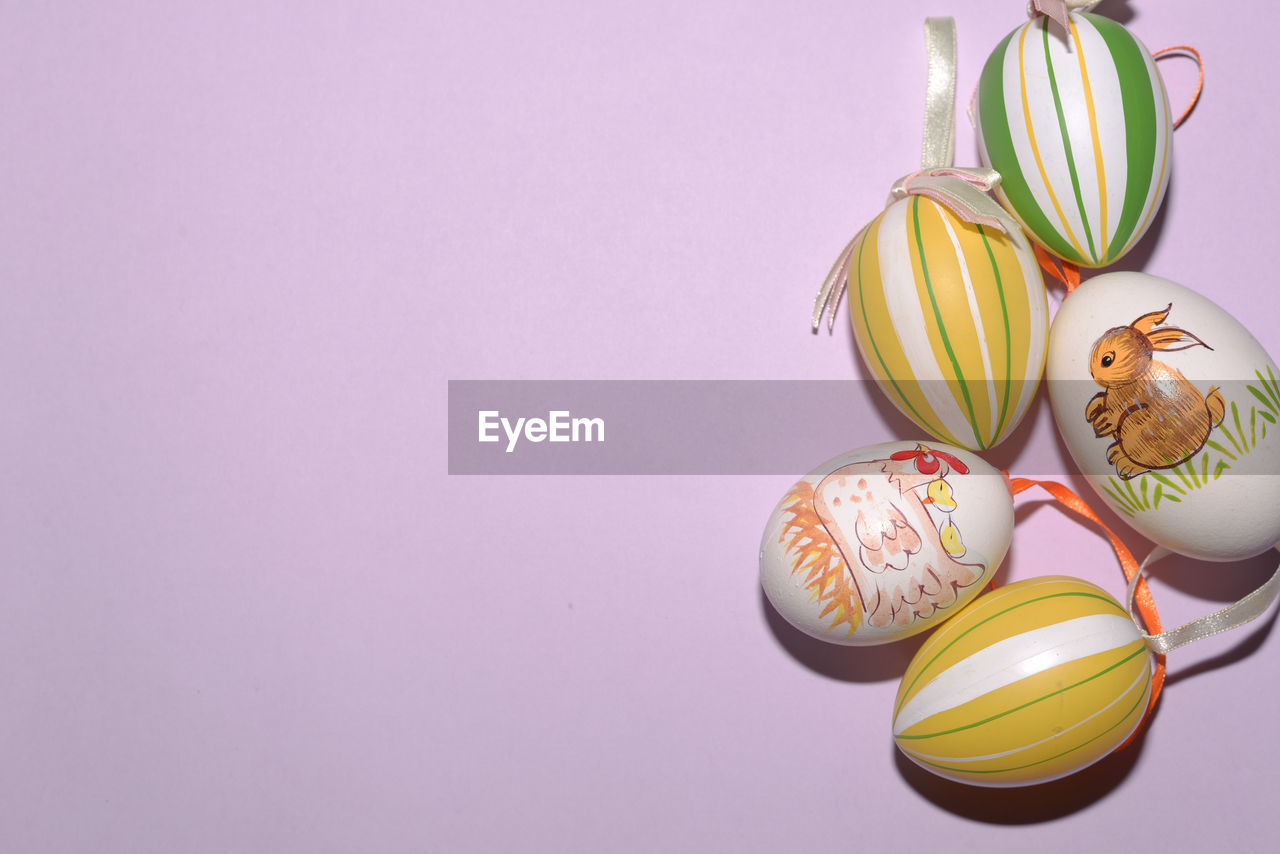 High angle view of easter eggs over pink background