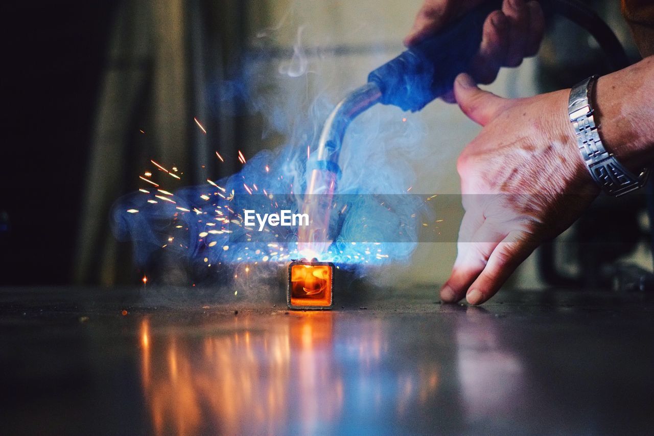 Close-up of man welding metal at workshop