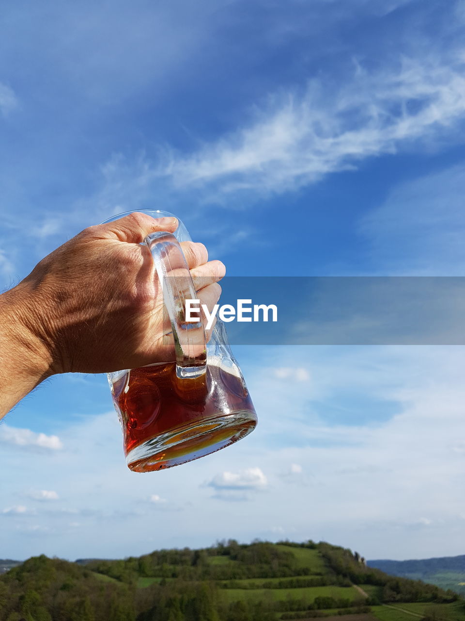 Close-up of hand holding beer glass