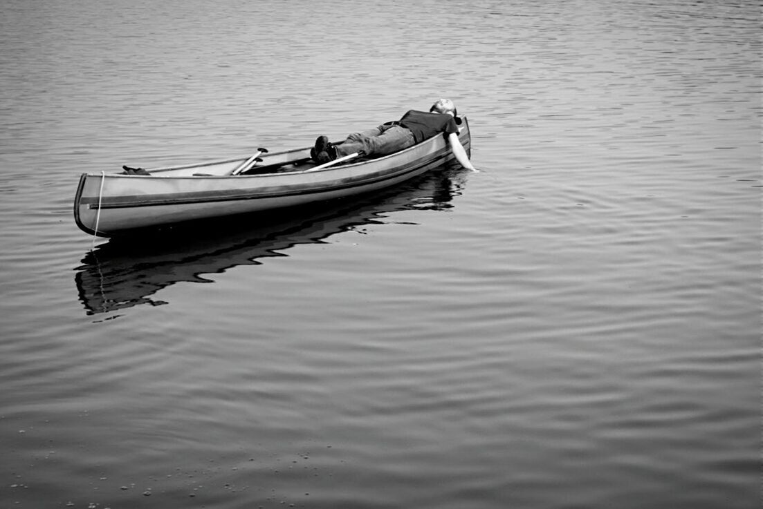 Man lying on rowboat