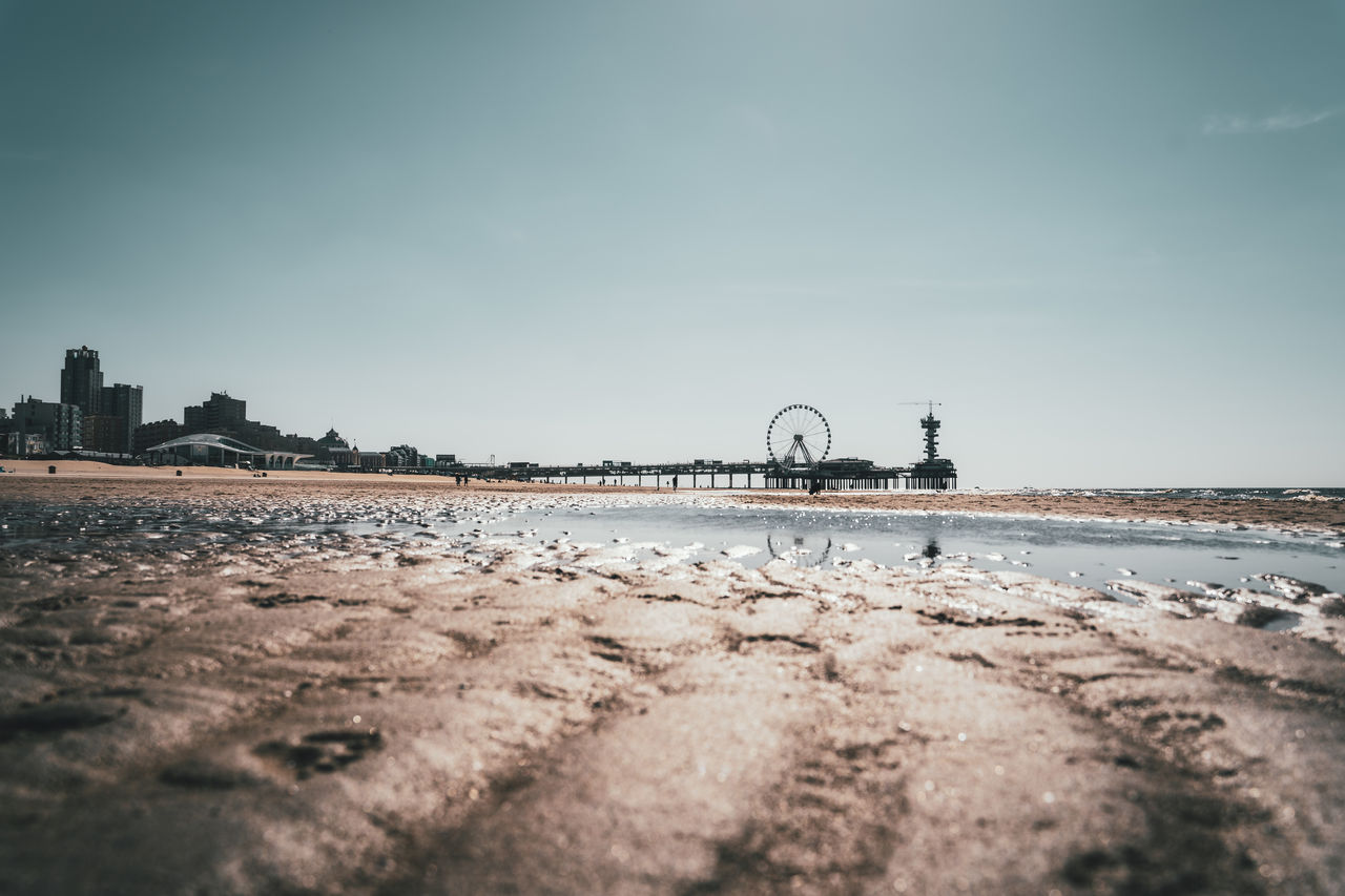 Long angle view of the ferris wheel on the pier of scheveningen with a reflection in the water