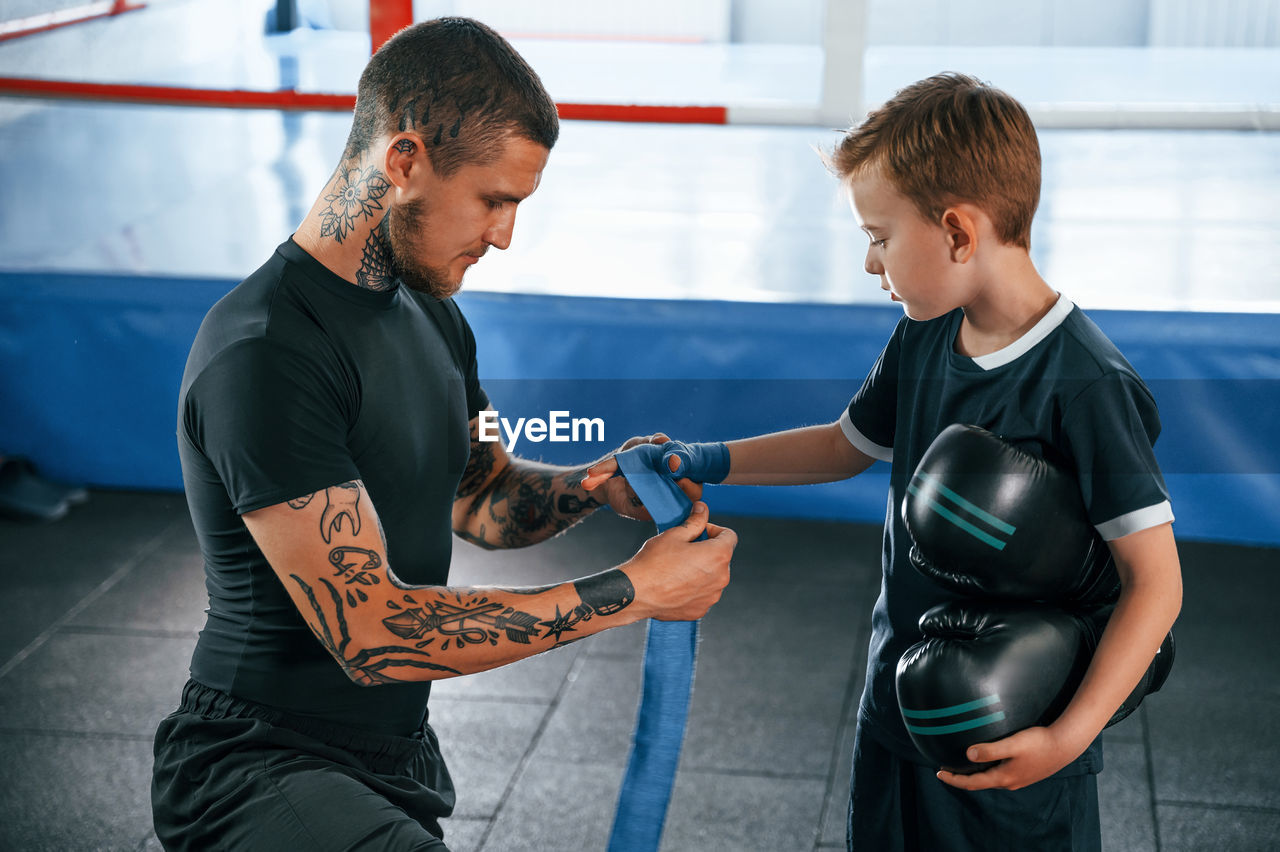 side view of young man exercising in workshop