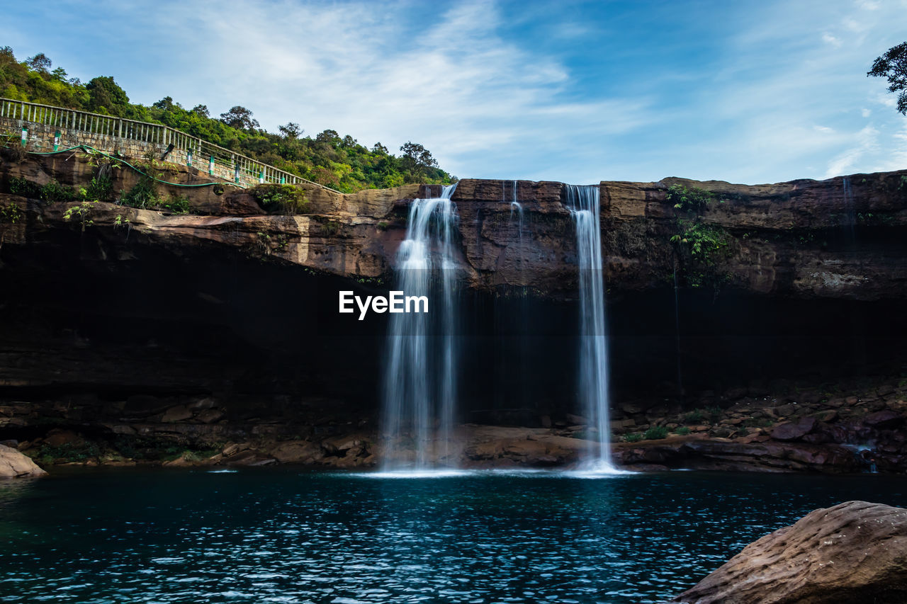 Waterfall streams falling from mountain top at morning long exposure shot from different angle