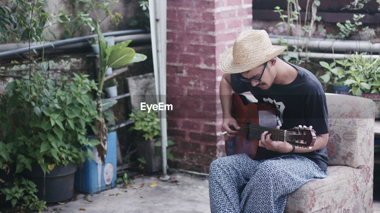 Man sitting and playing guitar