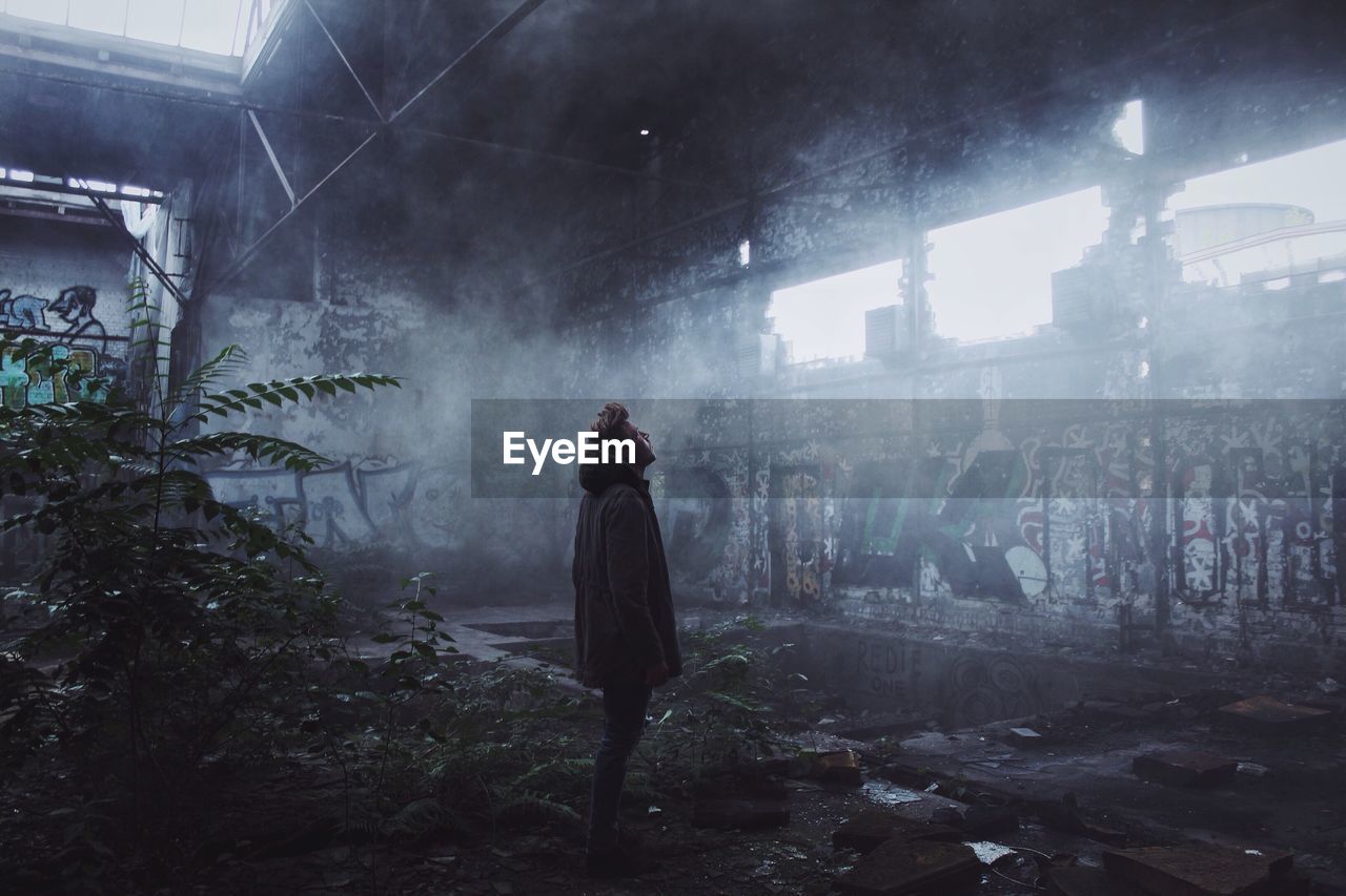 Man standing in abandoned building