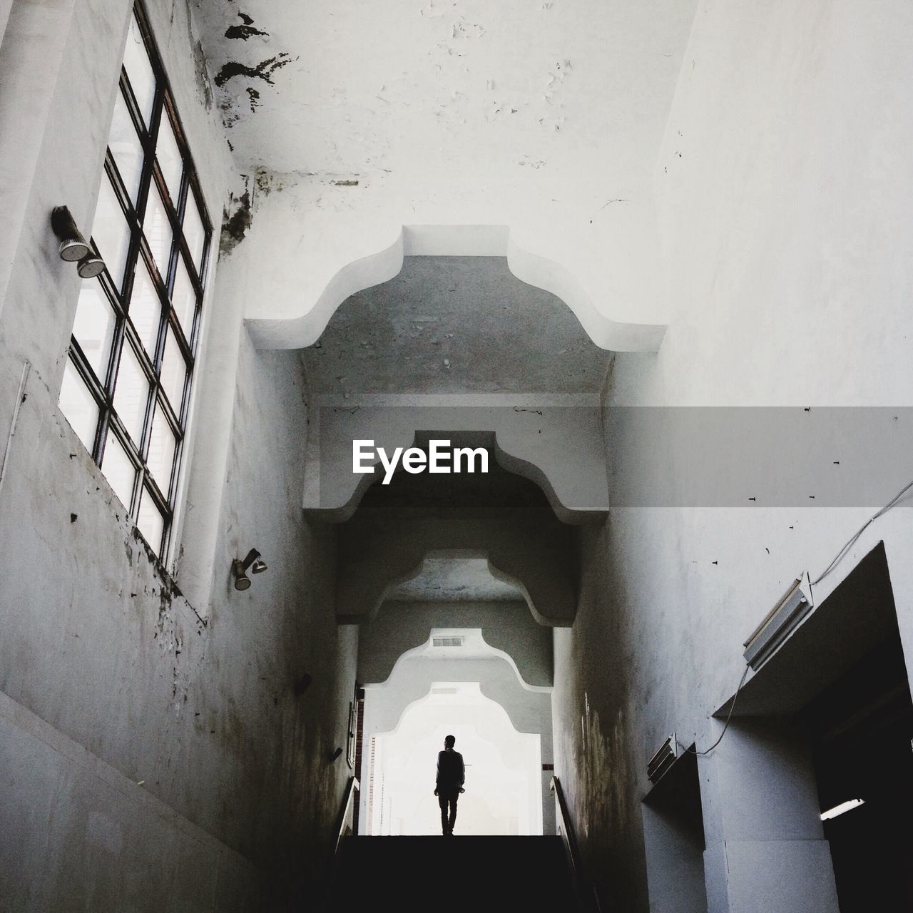 Silhouette of man standing in staircase