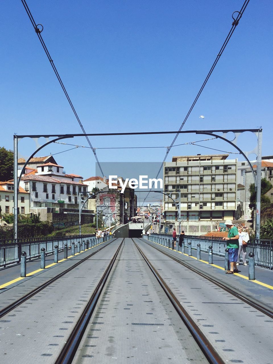 RAILROAD STATION BY BUILDINGS AGAINST SKY