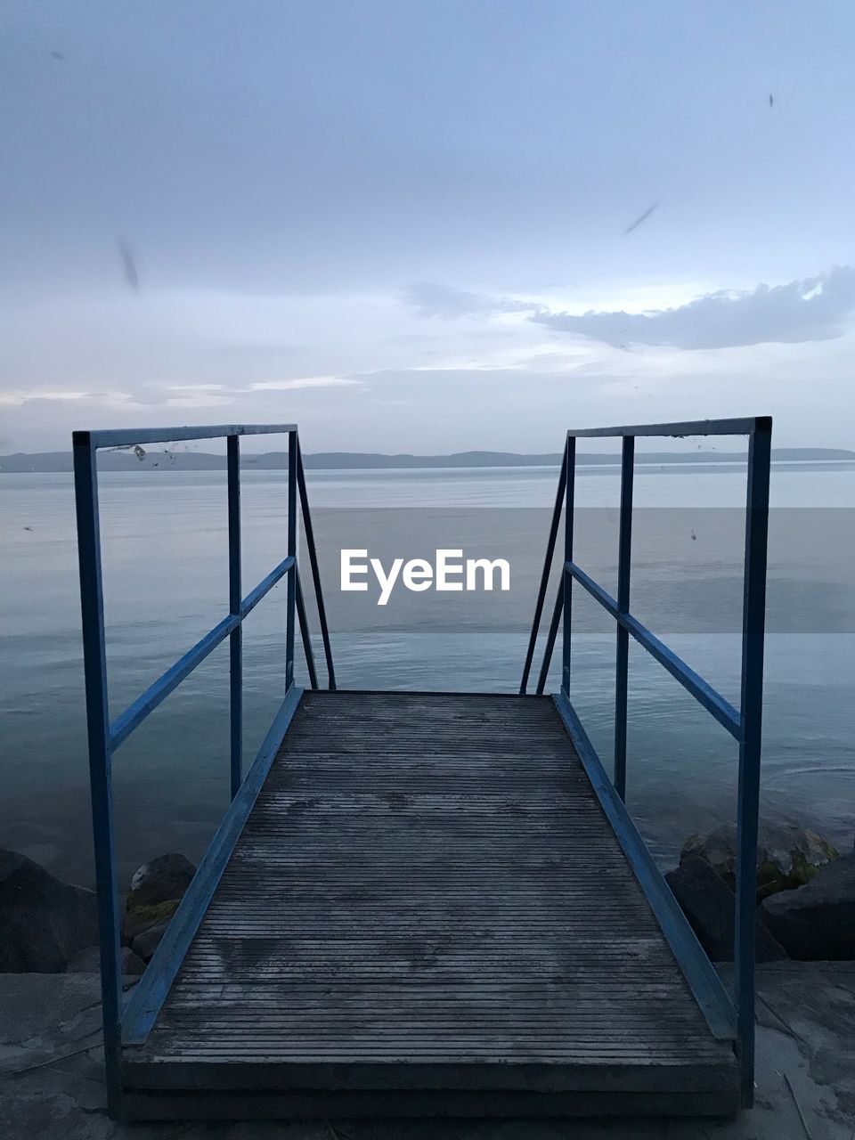 Pier over sea against sky