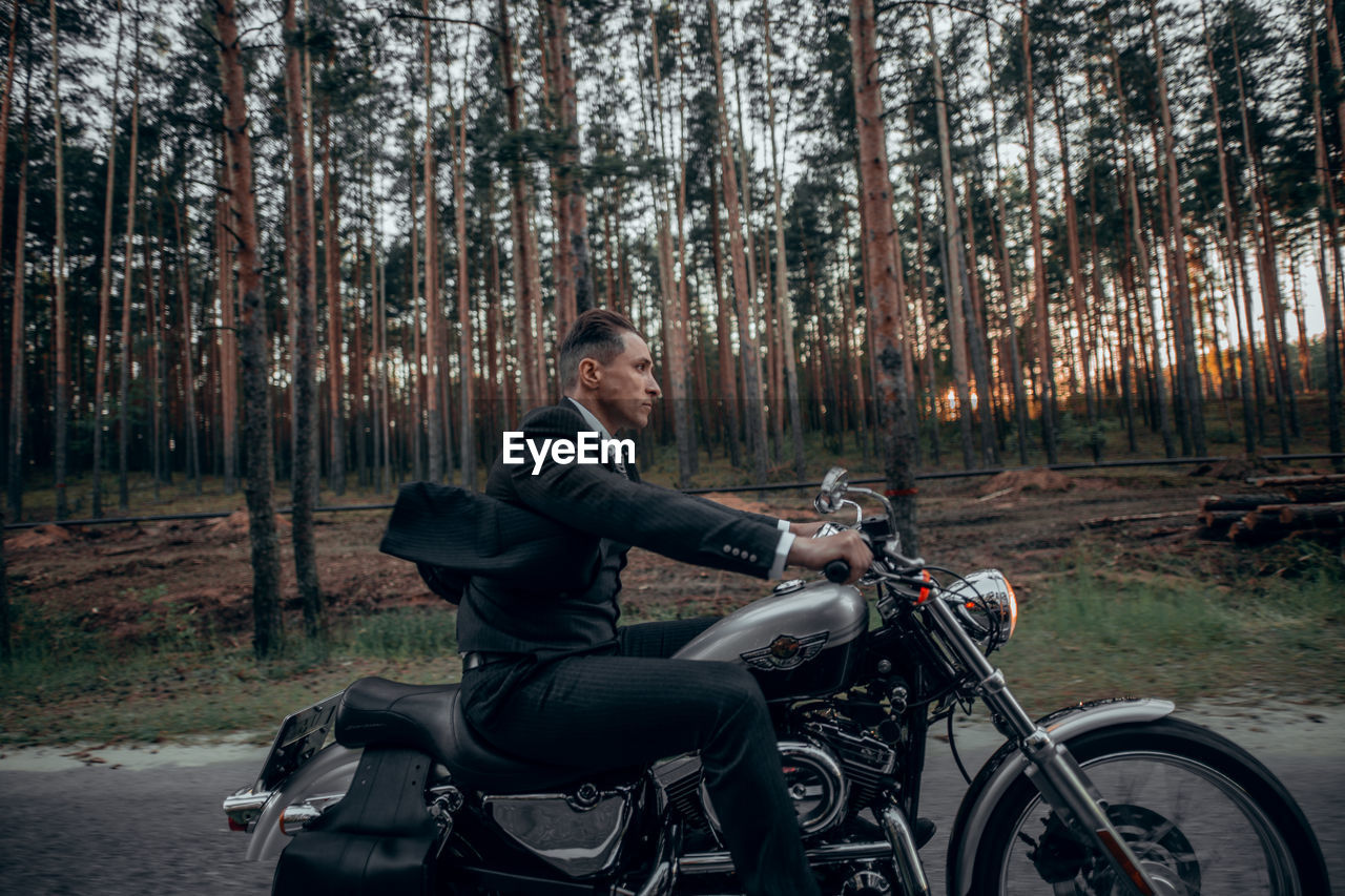 Man riding bicycle in forest