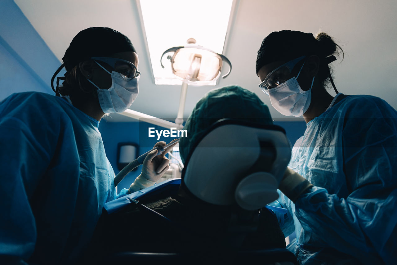 Dentists examining patient in clinic