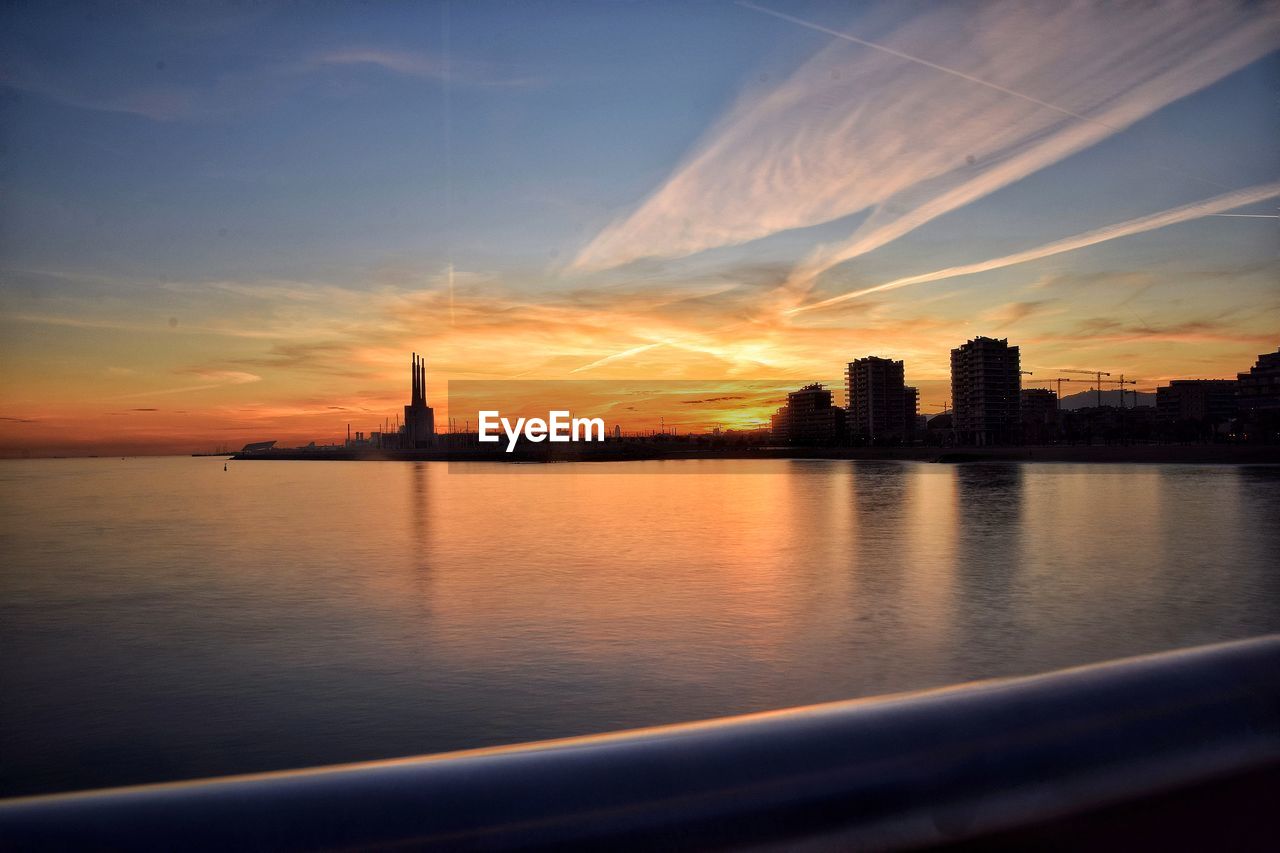 SCENIC VIEW OF BUILDINGS AT SUNSET