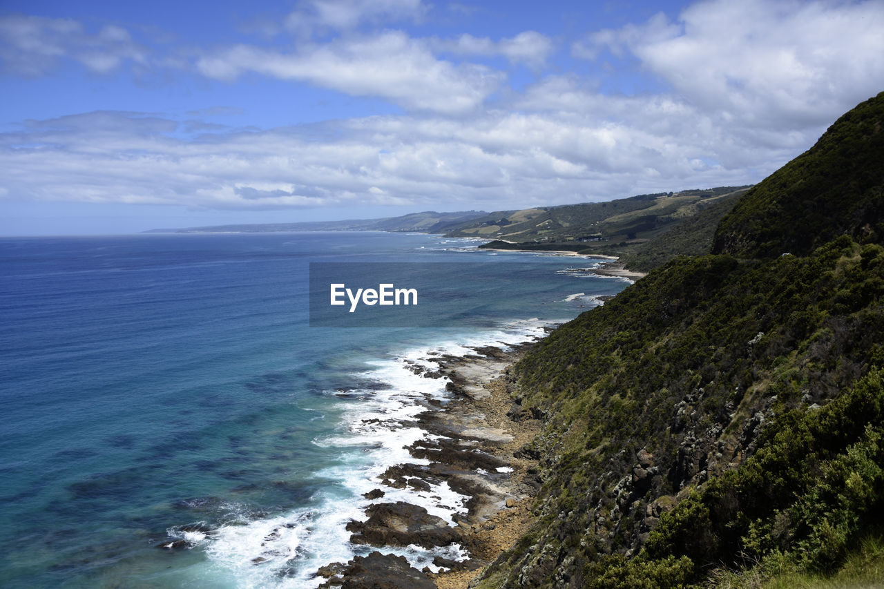 SCENIC VIEW OF SEA AND SHORE AGAINST SKY