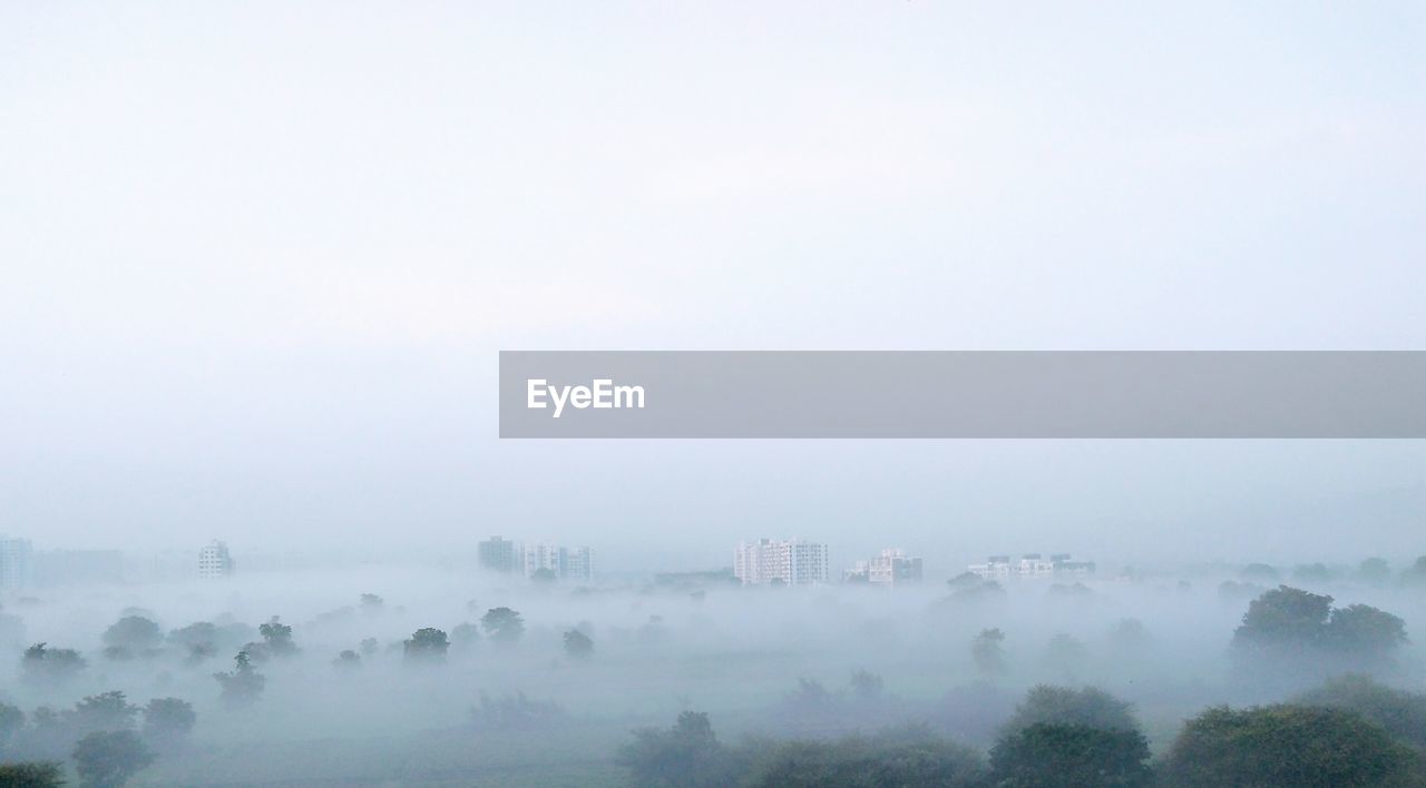 Panoramic view of city in foggy weather