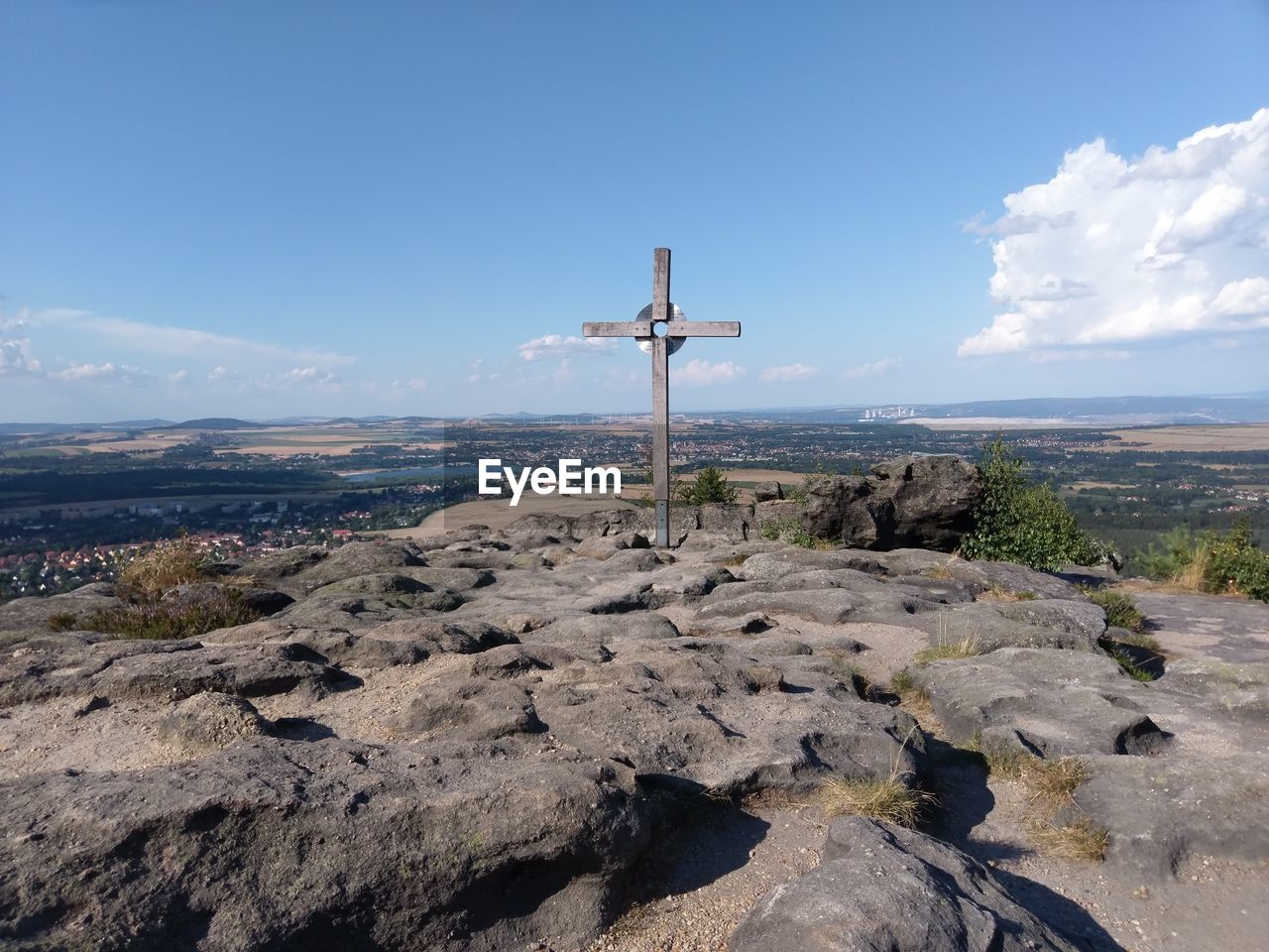 View of cross on land against sky