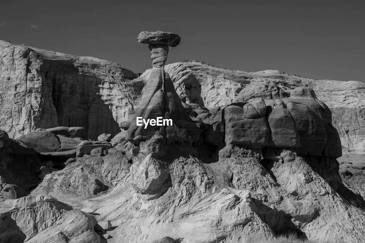 rock, black and white, monochrome, monochrome photography, mountain, white, black, nature, geology, rock formation, statue, terrain, day, one person, outdoors, person, sky, history, travel destinations, land, adult, the past, travel, ancient history, sculpture