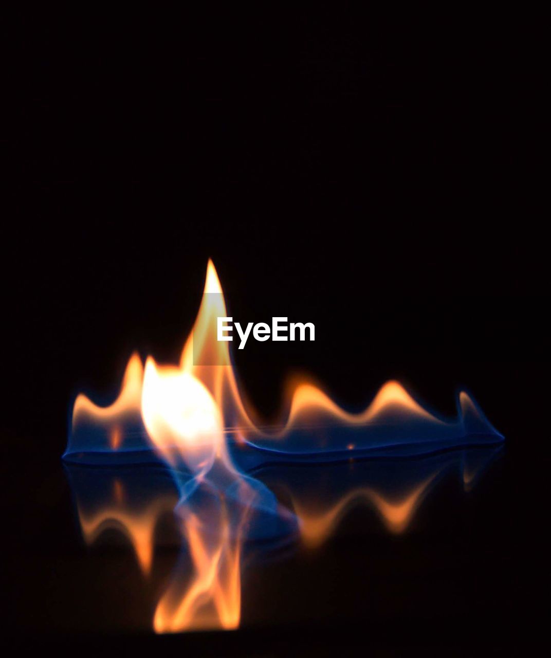 CLOSE-UP OF BURNING CANDLES