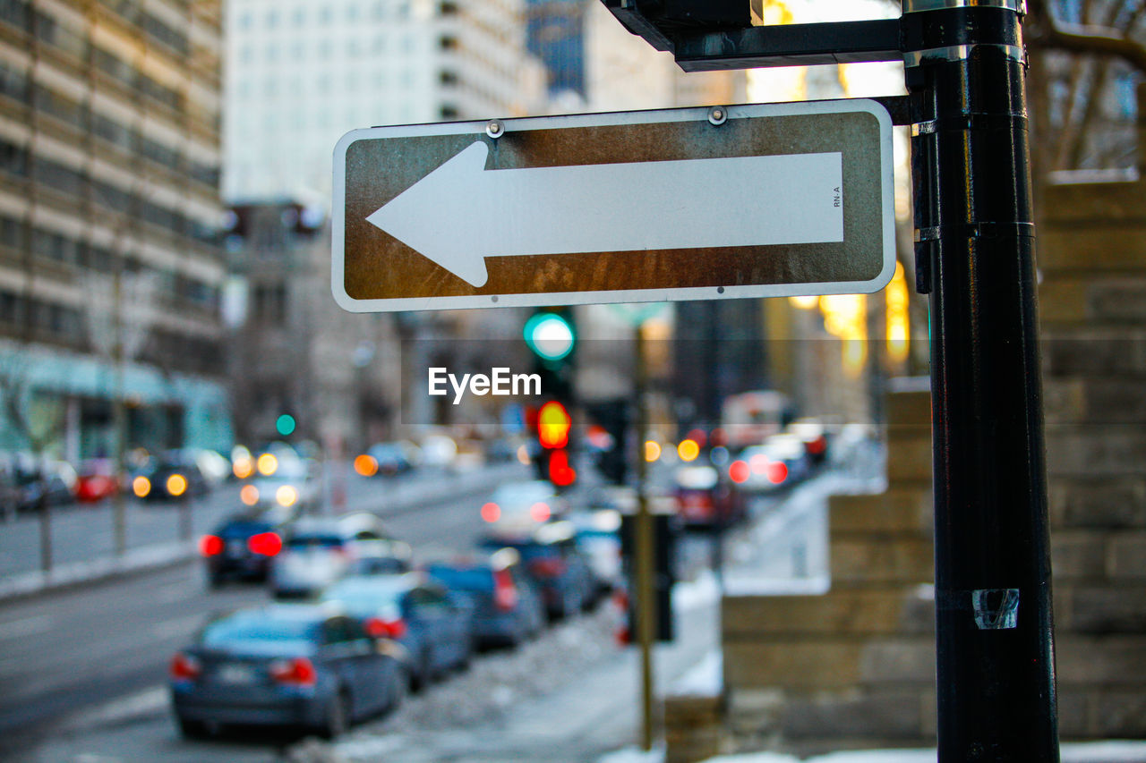 View of road sign on road in city