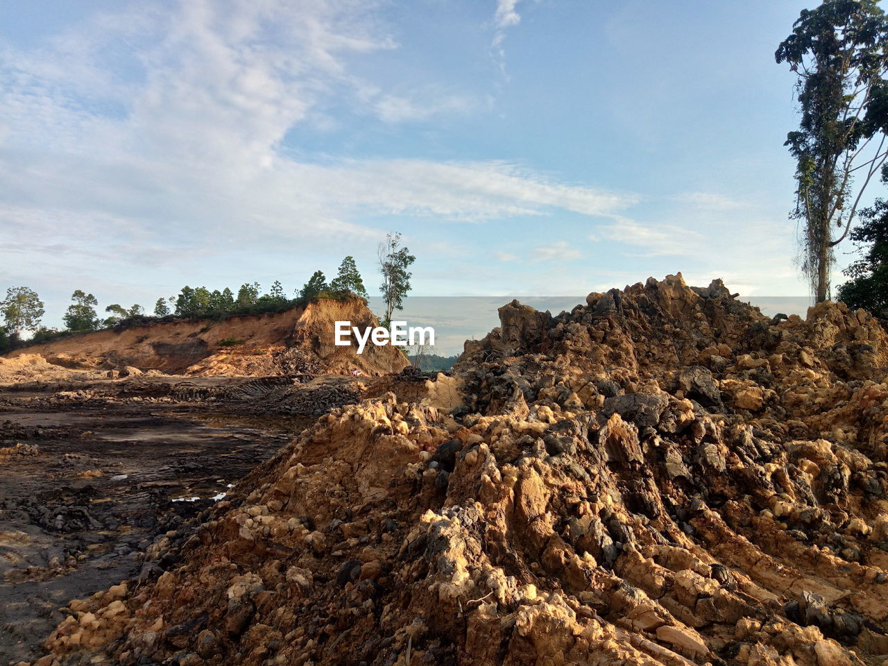 Rock formations on landscape against sky