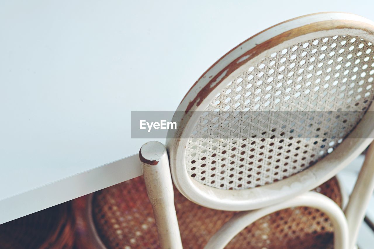 High angle view of a vintage chair and ikea table. old and modern contrast.