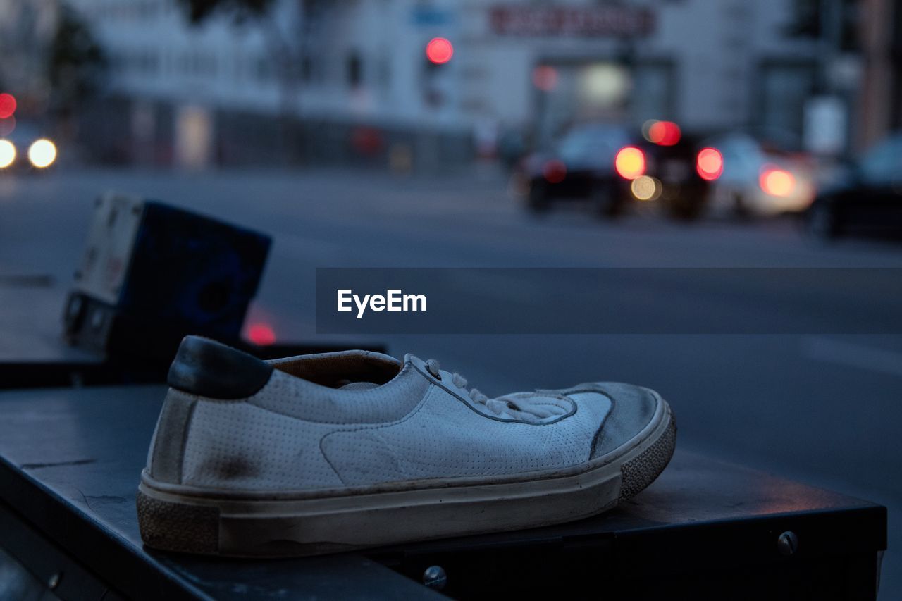 CLOSE-UP OF ILLUMINATED SHOES ON STREET