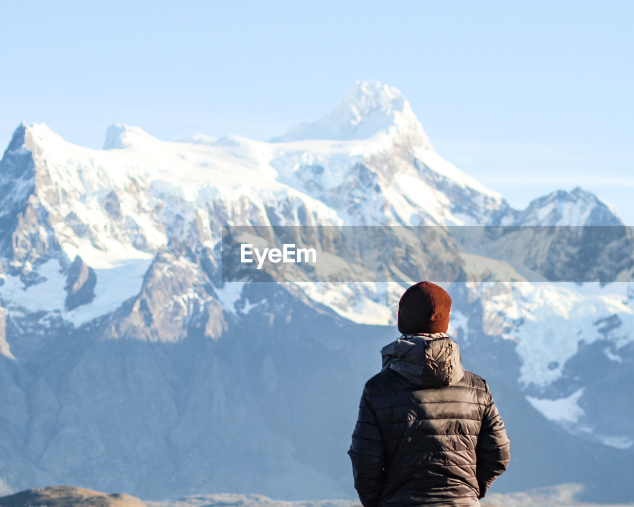 Man in torres del paine national park, chile, with snowy mountains in background