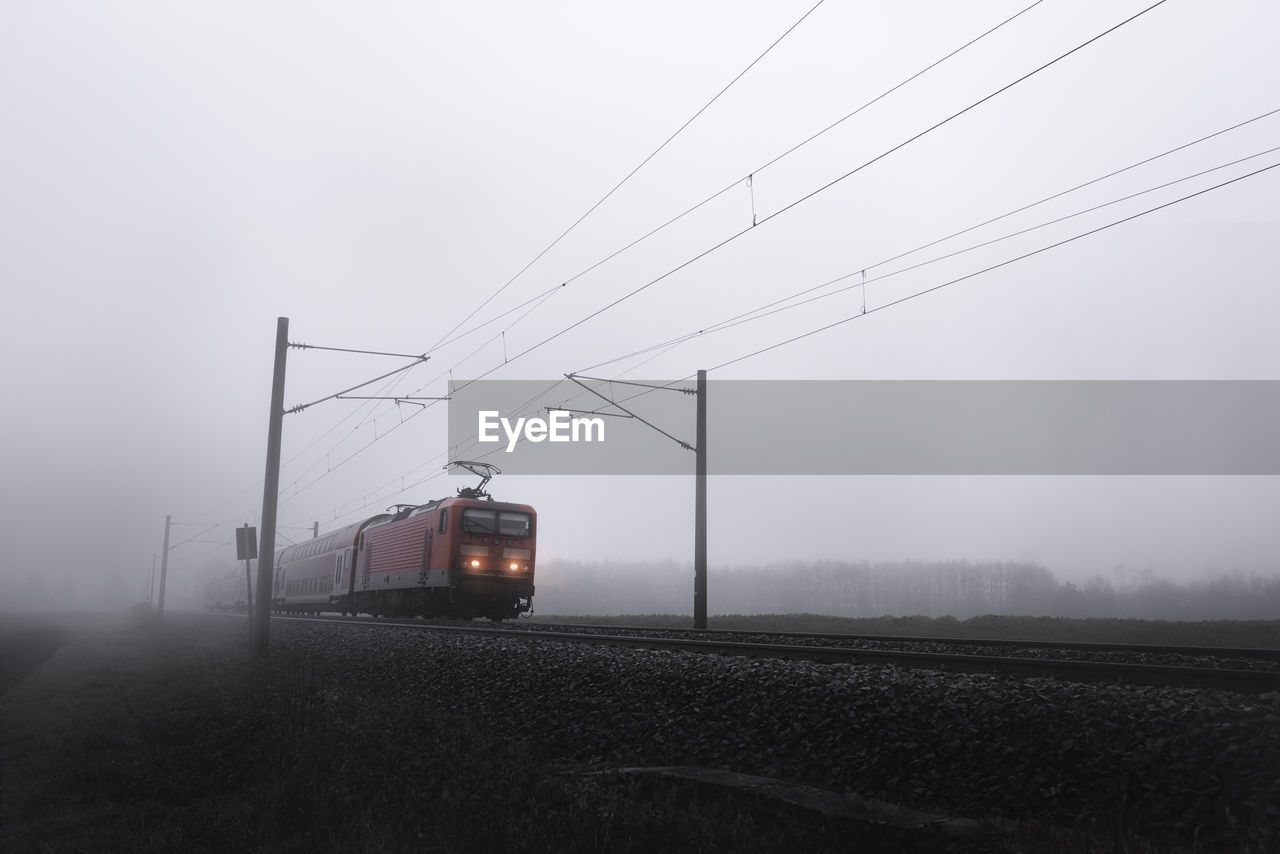 Train in foggy weather against sky