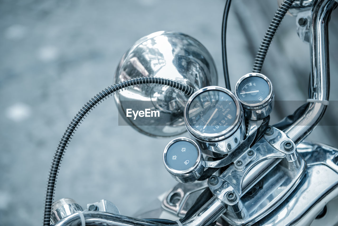 HIGH ANGLE VIEW OF METAL WHEEL WITH REFLECTION OF WATER