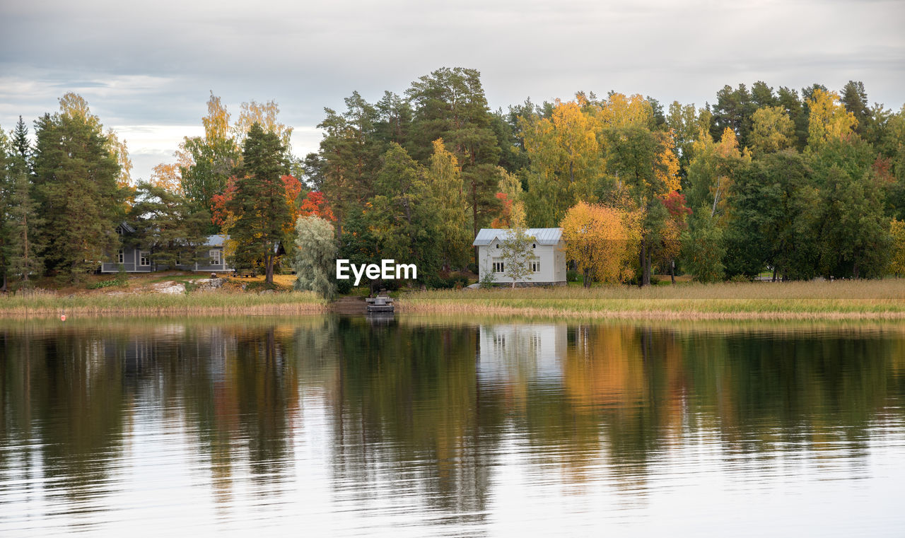 reflection, water, tree, autumn, plant, lake, nature, sky, beauty in nature, scenics - nature, cloud, leaf, tranquility, no people, landscape, environment, tranquil scene, forest, architecture, outdoors, non-urban scene, land, travel destinations, day, body of water, morning, travel