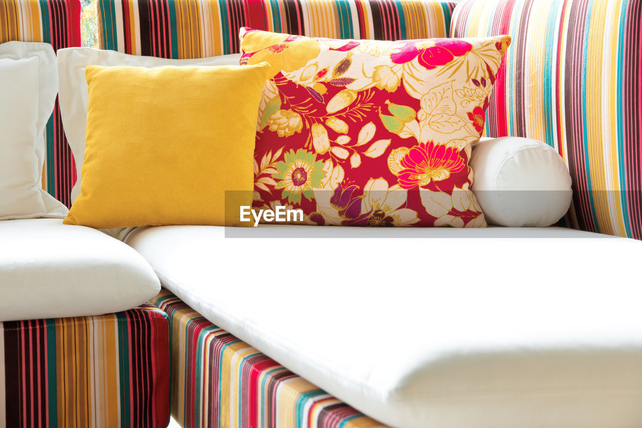 Close-up of cushions on colorful sofa