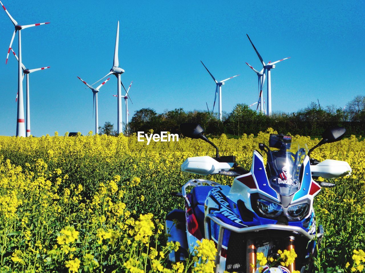 WINDMILL ON FIELD AGAINST SKY