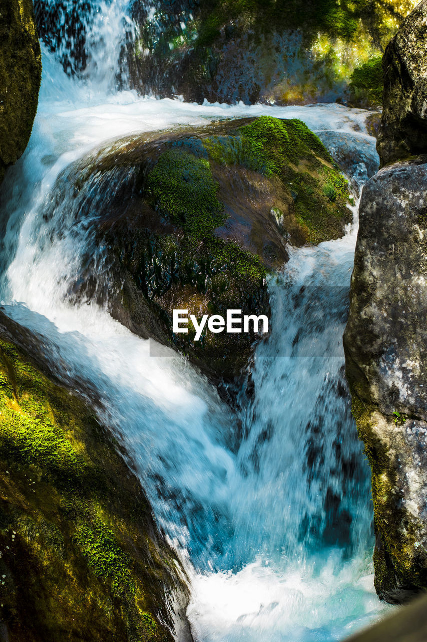 Scenic view of river flowing through rocks