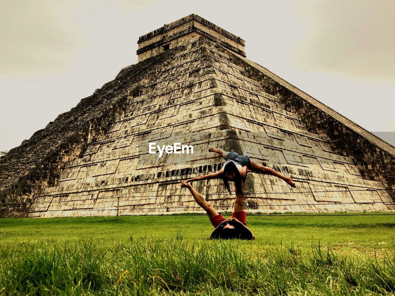 Couple exercising on grass by el castillo