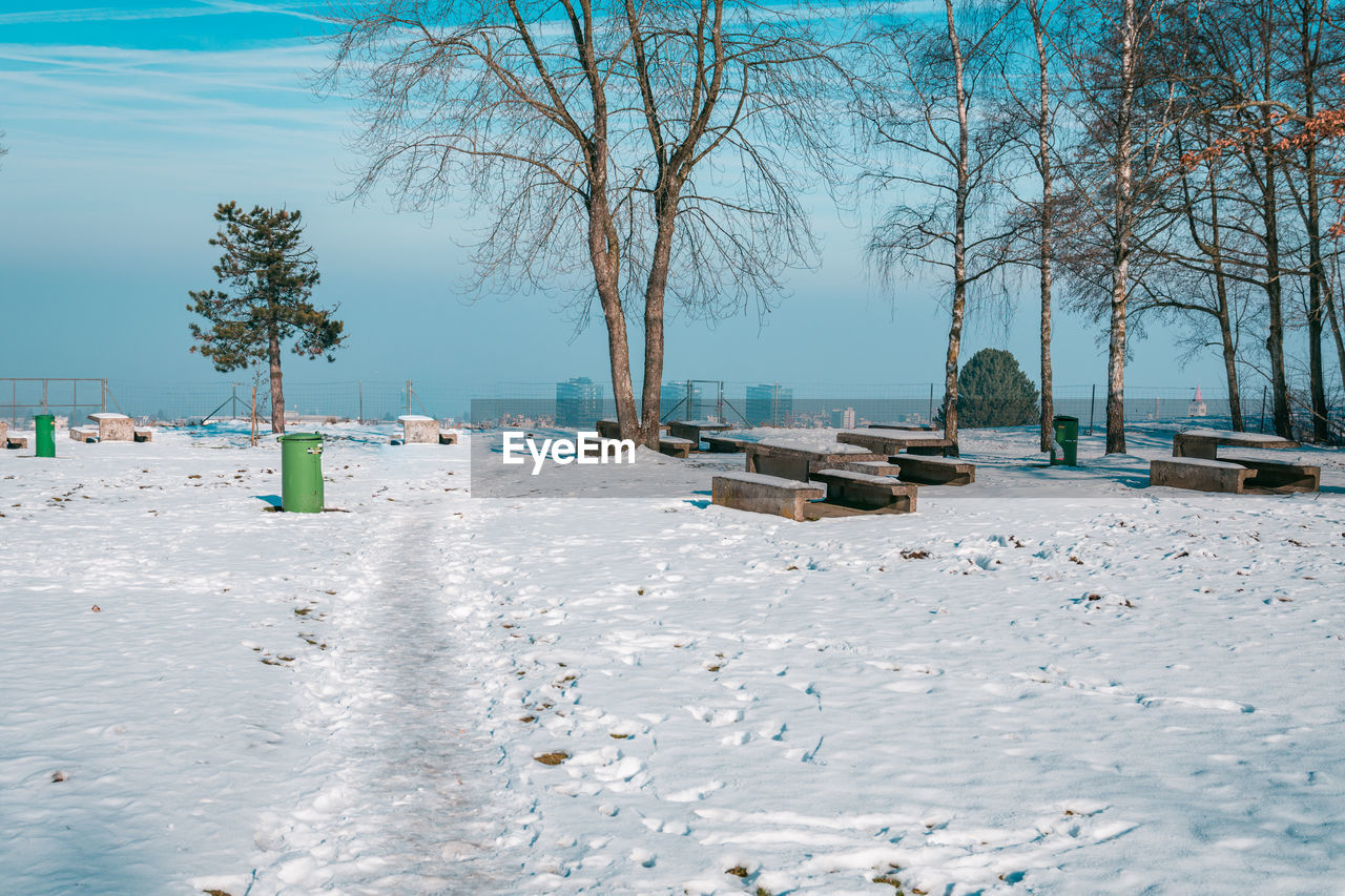 Scenic view of snow covered land against sky