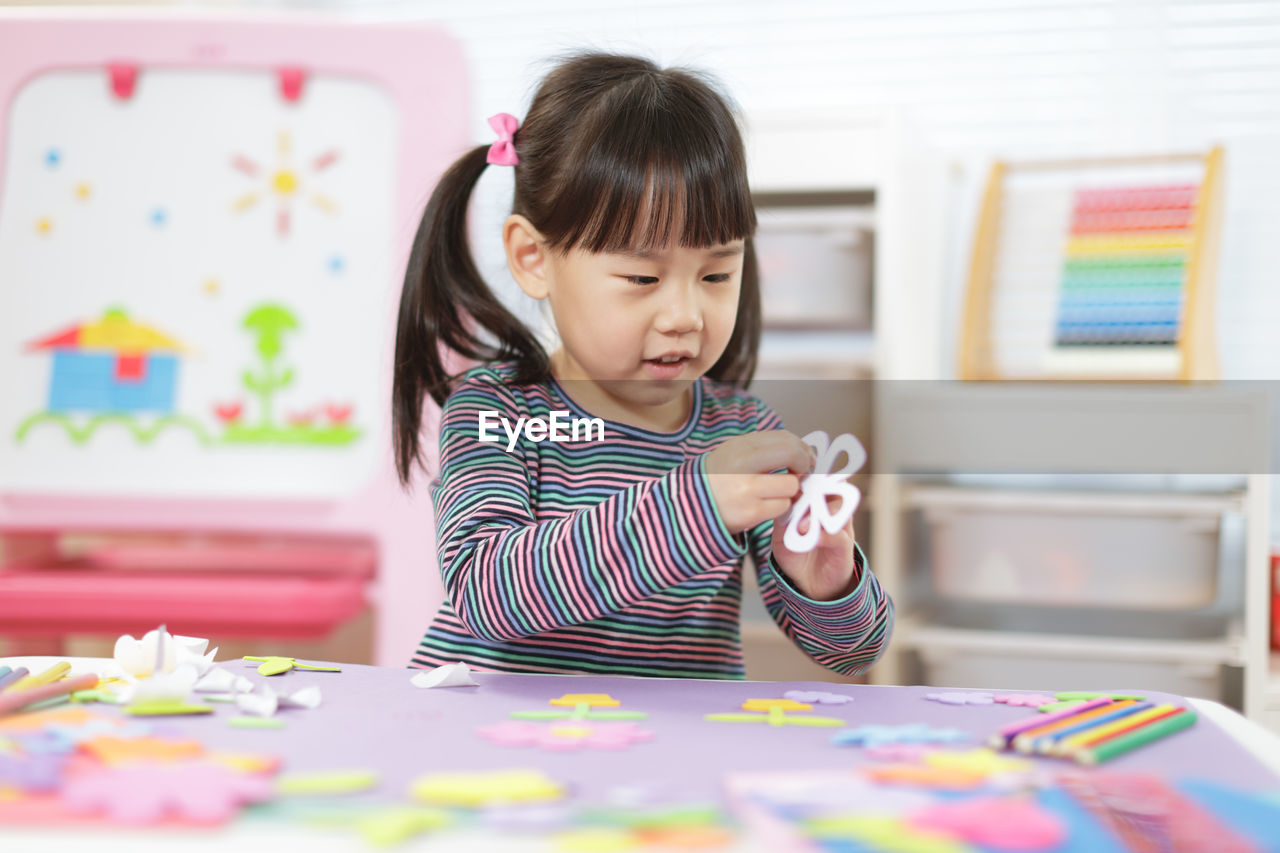 Young girl making craft for homeschooling