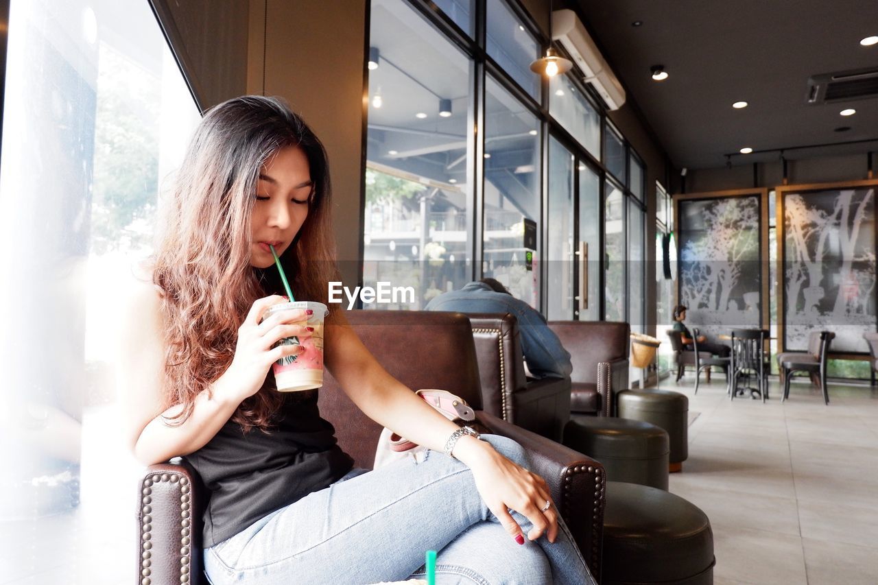 Woman sitting on table at cafe