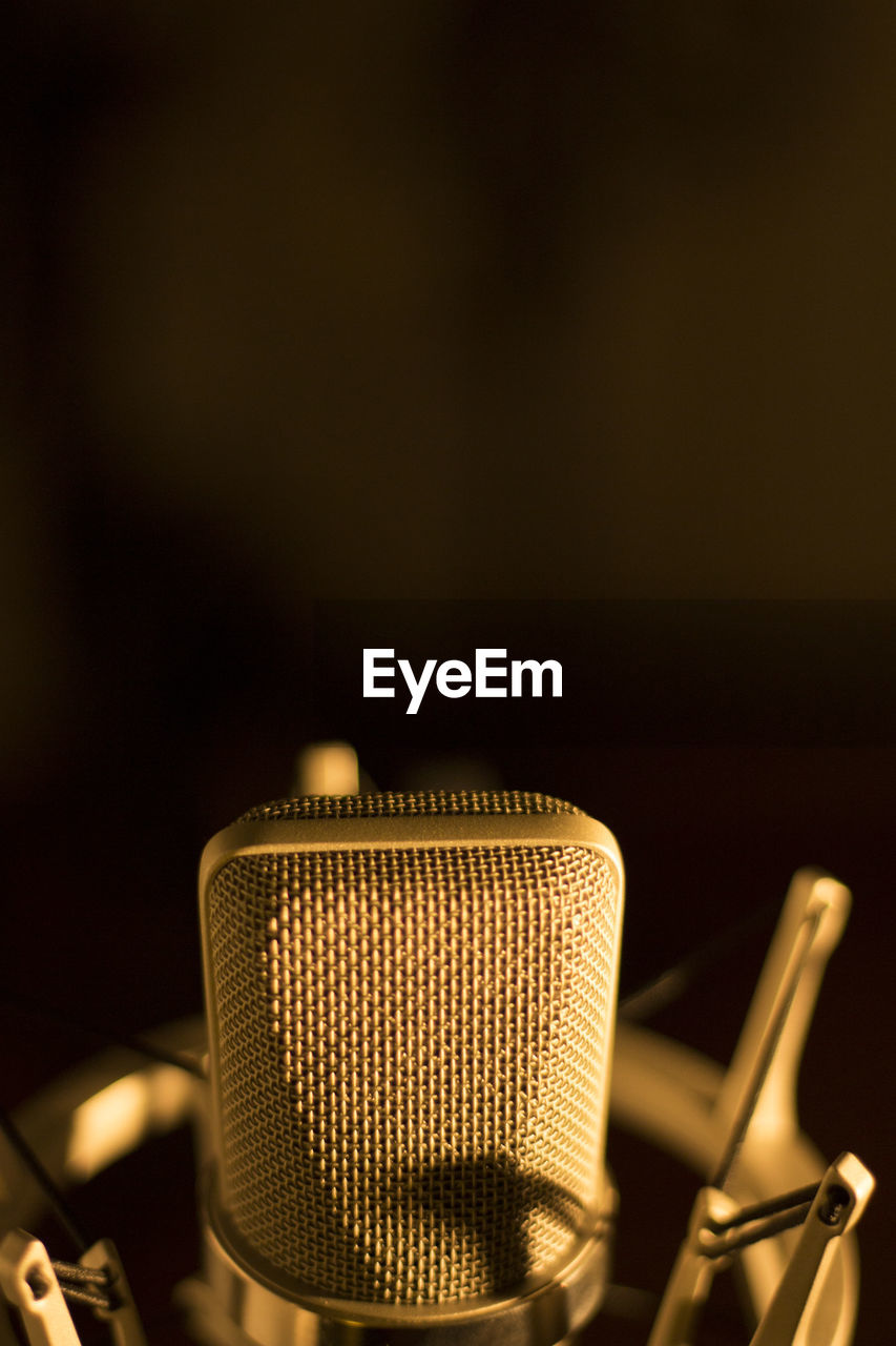 Close-up of microphone against black background