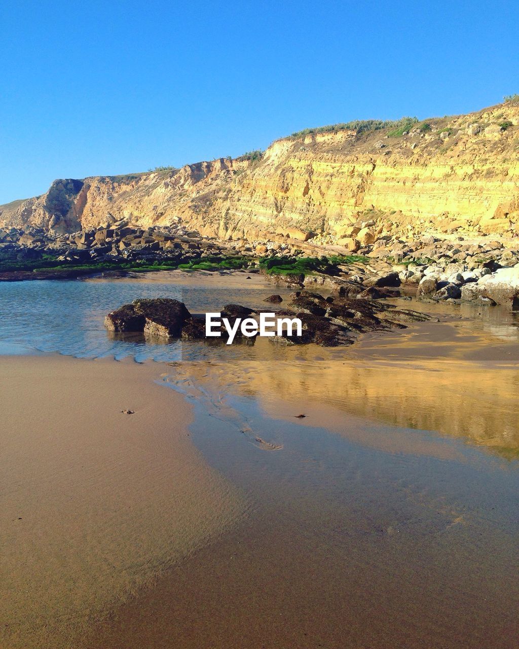 Scenic view of calm sea against clear sky